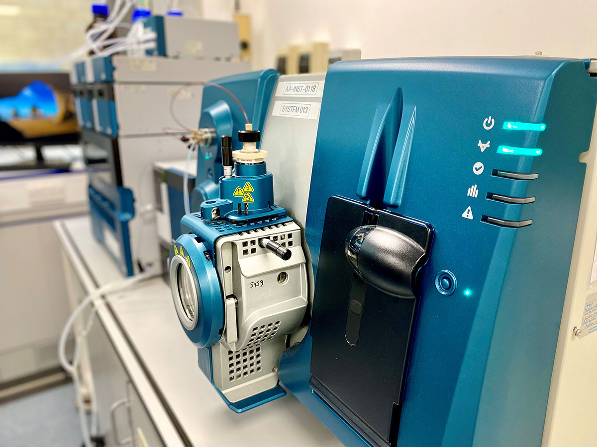 This image showcases a Sciex mass spectrometer, a sophisticated analytical instrument used in scientific labs. The device is designed for the detection, identification, and quantification of molecules in complex mixtures. Mass spectrometry is a crucial tool in various fields such as bioanalysis, pharmaceuticals, environmental testing, and more. The image captures the instrument's sleek design and advanced technology, emphasizing its capability to provide precise and accurate analysis. The visible indicators and controls suggest user-friendly operation, while the connection ports hint at the instrument's ability to interface with other lab equipment for comprehensive analytical workflows.