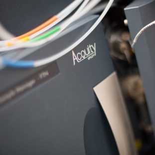 Close-up of the Acquity UPLC system, a state-of-the-art ultra-performance liquid chromatography unit, emphasizing Alderley Analytical's continuous enhancement of their analytical capabilities. The focus on the Acquity branding highlights the incorporation of advanced technology in their laboratory, supporting the 'Another Mass Spectrometer Arrives' blog narrative about expanding resources to meet growing research and analysis demands.