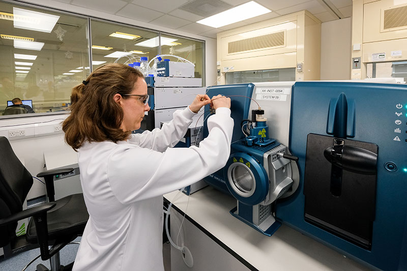 female scientist working with equipment in clinical bioanalysis services laboratory